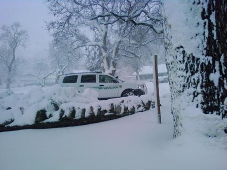 Patrol Car Surrounded by Snow